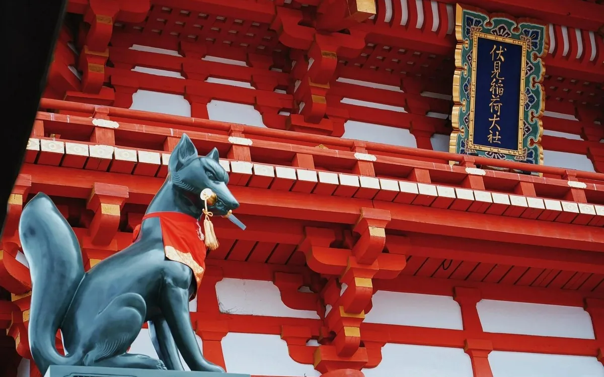 A stone fox statue holding a key in its mouth