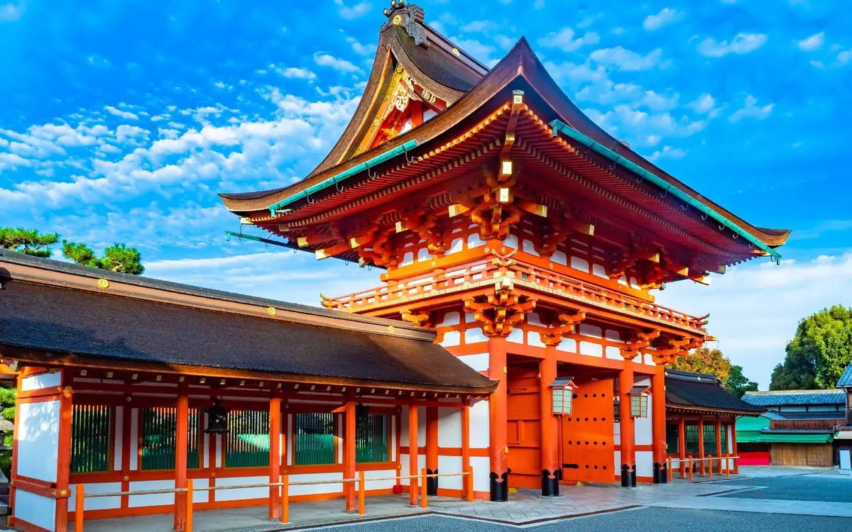 The vermilion buildings of Fushimi Inari Taisha seen from the approach